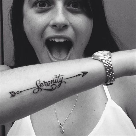 Forearm Tattoo Of An Arrow Crossing The Word