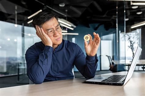 Premium Photo Frustrated Asian Businessman Investor Holding Crypto