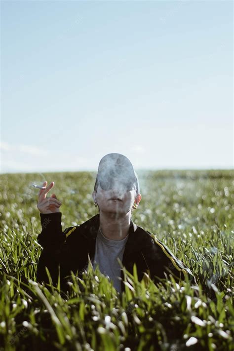 premium photo girl  boy smoking   field