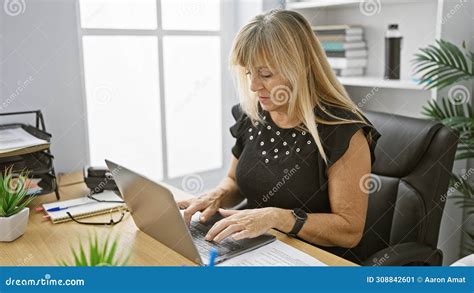 Serious Yet Relaxed Beautiful Middle Aged Blonde Business Woman Successfully Bossing Around