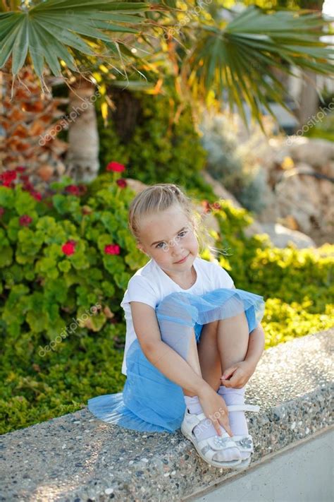 Beautiful Blonde Girl Years Old In A Blue Skirt On Background Stock