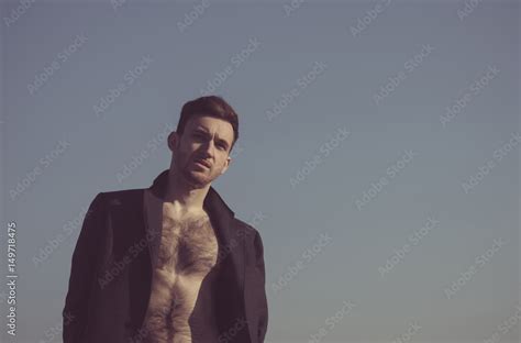 Handsome Man Posing In Unbutton Coat With Hairy Naked Torso Stock Photo Adobe Stock