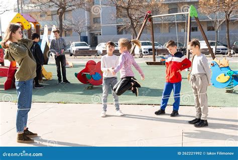 Children Skipping On Elastic Jump Rope Stock Photo Image Of Cheerful