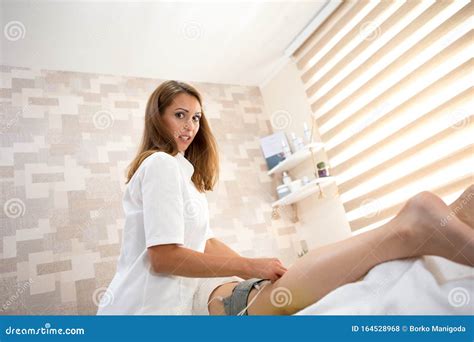 The Beautiful Brunette Nurse Is Surprised And Looks At The Camera She Is At A Medical Clinic