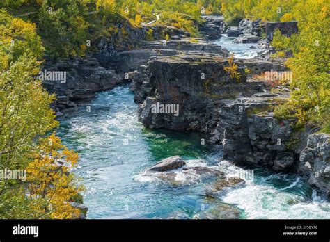 Wild Abisko river flows swiftly through rocky gorge in Abisko National ...