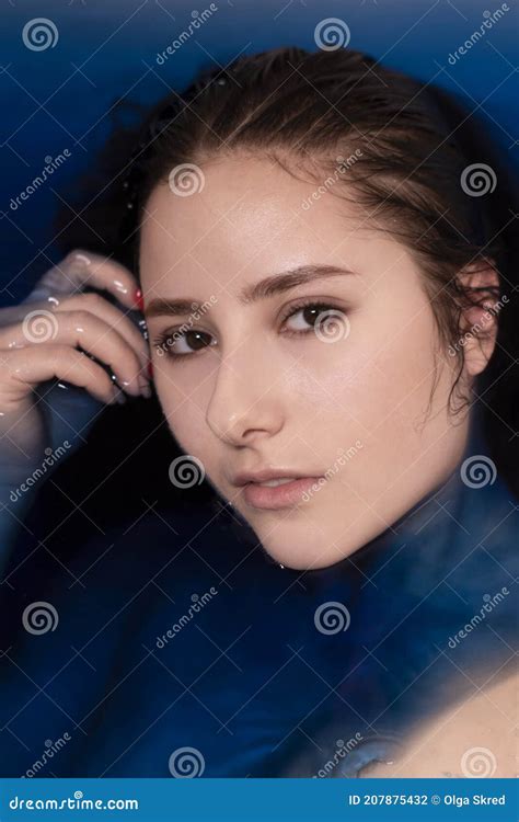 Portrait Of Attractive Brunette Woman Topless In Blue Liquid In Bathtub With Colored Water
