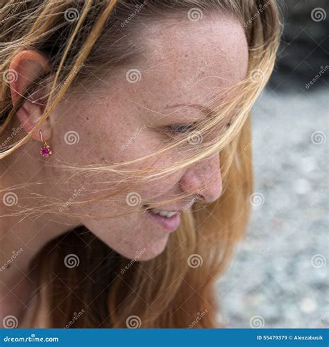 Ginger Girl Stands Knee Deep In Sea Water And Adjusts Her Bikini Royalty Free Stock Photo