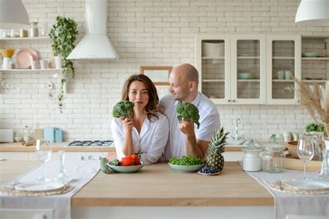 Premium Photo Romantic Young Couple Cooking Together In The Kitchen