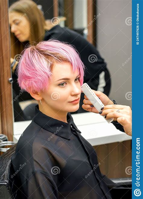 Hairdresser With Comb Is Checking Out And Fixing The Short Pink