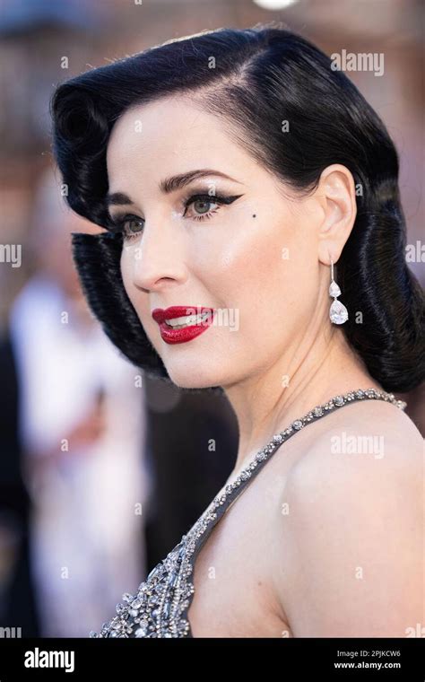 Dita Von Teese poses for photographers upon arrival at the Olivier