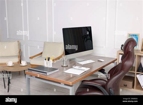 Receptionist Workplace With Computer And Waiting Area Interior Design