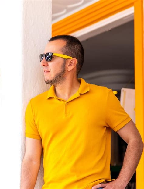 Premium Photo Midsection Of Man Wearing Sunglasses Standing Against Wall