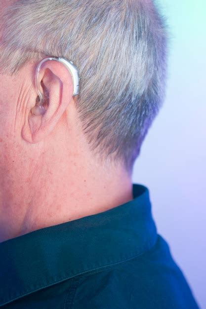 Premium Photo Close Up Of Senior Man Wearing Hearing Aid Indoors