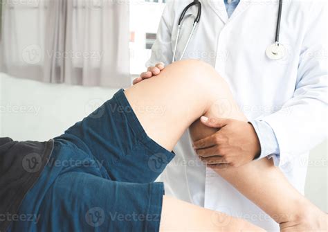 Physiotherapist doing healing treatment on patient leg sport physical