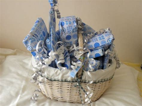 A Wicker Basket Filled With Blue And White Baby Items