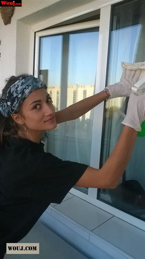 Pretty Brunette Chick Showing Her Ass While Cleaning A Window Photos