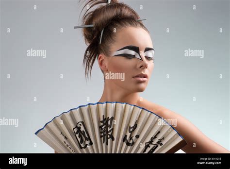 Sexy Brunette With Japan Make Up And Asian Fan She Looks Down At Left Stock Photo Alamy