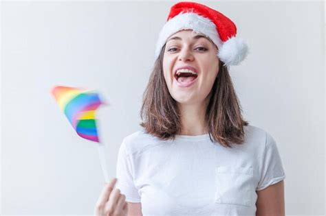 Premium Photo Beautiful Lesbian Girl In Red Santa Claus Hat With Lgbt Rainbow Flag Isolated On
