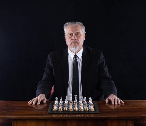 Premium Photo | Grandmaster in a suit playing chess