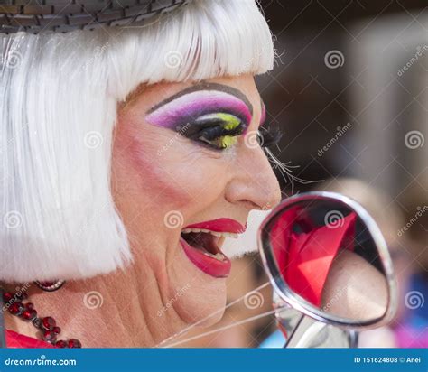 A Dressed Up Man In A Crazy Female Car Dress Attending The Gay Pride Parade Also Known As