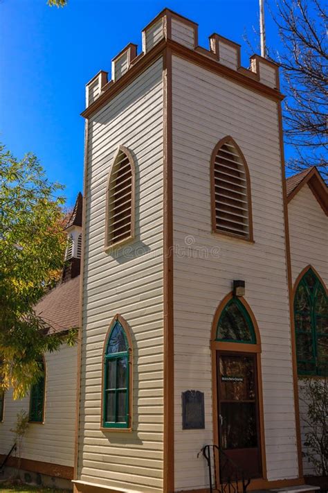 A Tall White Building With A Steeple And Arched Windows Stock Image