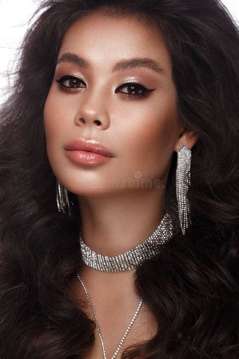 Beautiful Asian Brunette Model With Volume Curls Classic Makeup And Lips The Beauty Of The