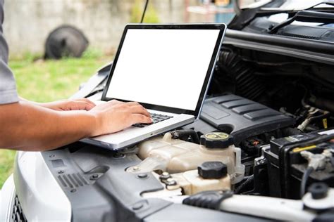 Premium Photo Cropped Hands Of Mechanic Using Laptop While Repairing