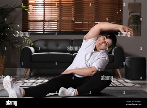 Overweight Mature Woman Doing Exercise At Home Stock Photo Alamy