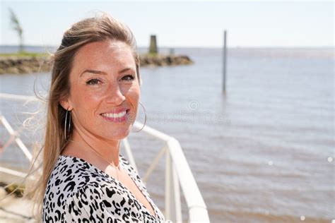 Blonde Beautiful Woman On A Seafront Promenade During Vacation Stock Photo Image Of Cheerful