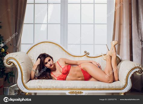 Beautiful Brunette In Red Lingerie On A White Couch Stock Photo Vershinin Photo 228763776