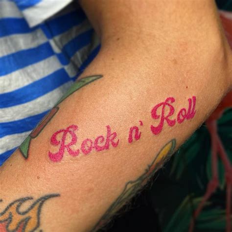 Rock N Roll Lettering Tattoo Located On The Forearm