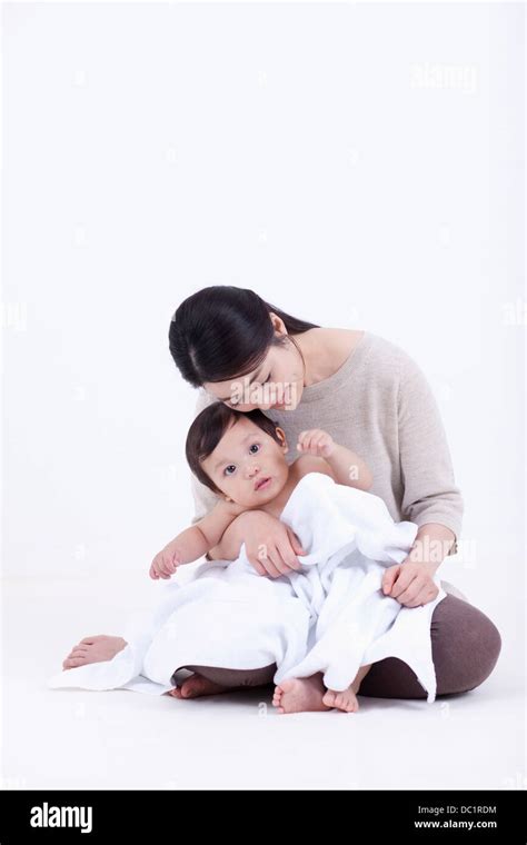 Baby Sitting On Mothers Lap Stock Photo Alamy