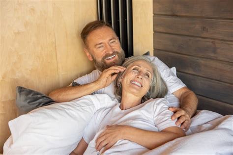 Mature Couple Staying In Bed And Feeling Close And Relaxed Stock Photo Image Of Retired
