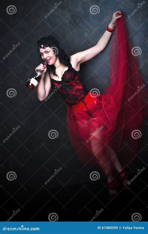 Happy Beautiful Brunette Woman In Corset And Long Hair With Bottle Of Red Wine Stock Image
