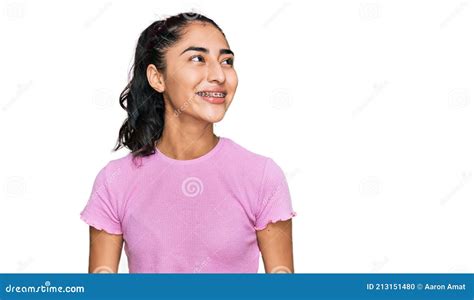 Hispanic Teenager Girl With Dental Braces Wearing Casual Clothes