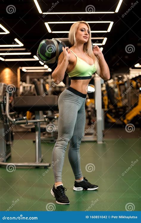 Fitness Blonde Woman Is Standing With Sand Bag In The Gym Stock Photo Image Of Athlete Female
