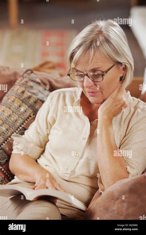 Mature Caucasian Woman Reading A Book At Home Stock Photo Alamy