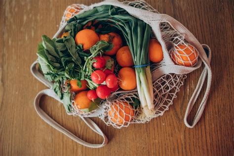 Una Bolsa De Frutas Y Verduras Sobre Una Mesa Foto Premium