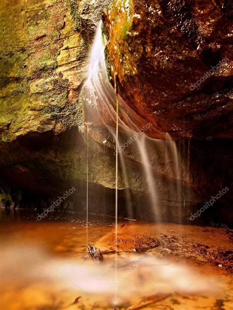 Small waterfall on small mountain stream, mossy sandstone block and ...