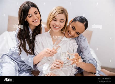Bridal Party Multicultural Girlfriends Clinking Glasses With Champagne Celebration Brunette