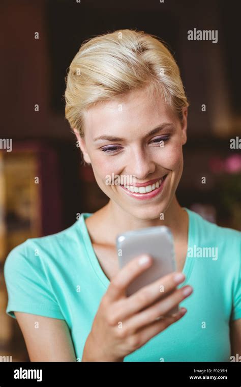 Pretty Blonde Woman Using Her Smartphone Stock Photo Alamy