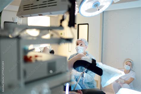 Gynecologist Operating Patient In Gynecological Chair Doctor Performs