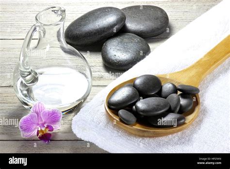 Basalt Stones For Hot Stone Massage With Accessories On Wooden Background Stock Photo Alamy