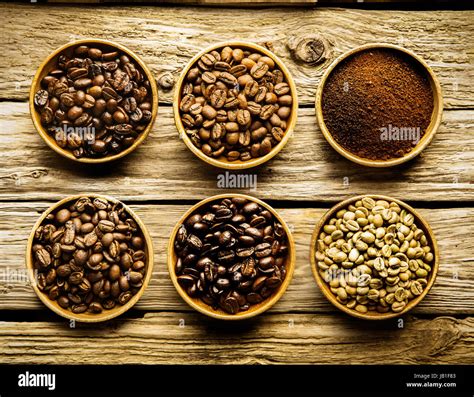 Five Varieties Of Coffee Beans And Ground Powder Is Separate Dishes