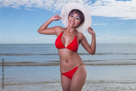 Sexy Asian Red Bikini Female Lady Model Having A Great Holiday By A Beach And Posing Happily