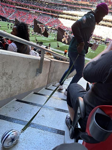 Eagles fan toting around a Cowboys helmet on a leash at the Falcons