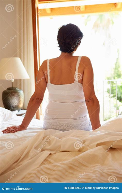 Rear View Of Woman Waking Up In Bed In Morning Stock Photo Image Of Mature Hispanic