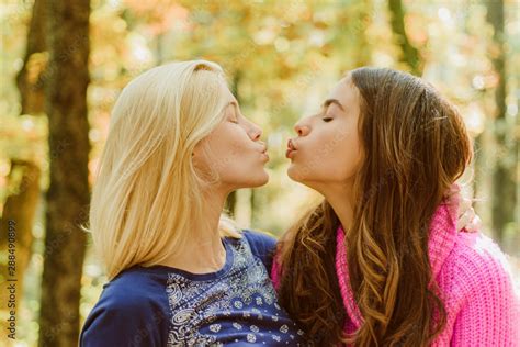 Foto Stock Friendly Kiss Girls Friends Kissing Girlish Friendship Concept Blonde And Brunette
