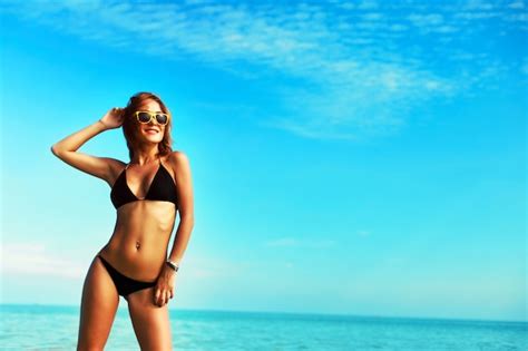 Sourire Femme En Bikini Appréciant Le Ciel Bleu Photo Gratuite