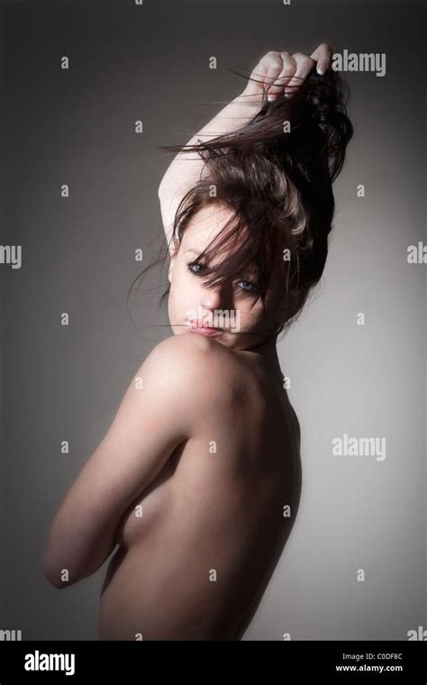 Beautiful Nude Woman With Dark Hair Standing Isolated On Gray Stock Photo Alamy